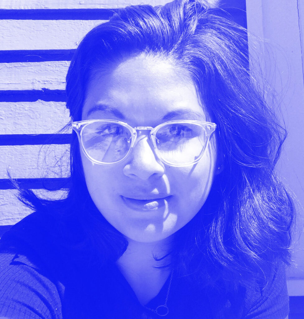 Headshot of Annie Canto - blue toned image. Female face wearing glasses.