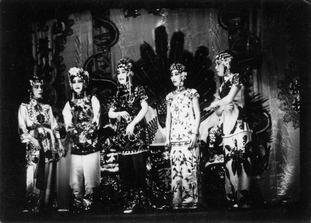 A black and white photo from the 1930s showing five Chinese Opera performers on stage